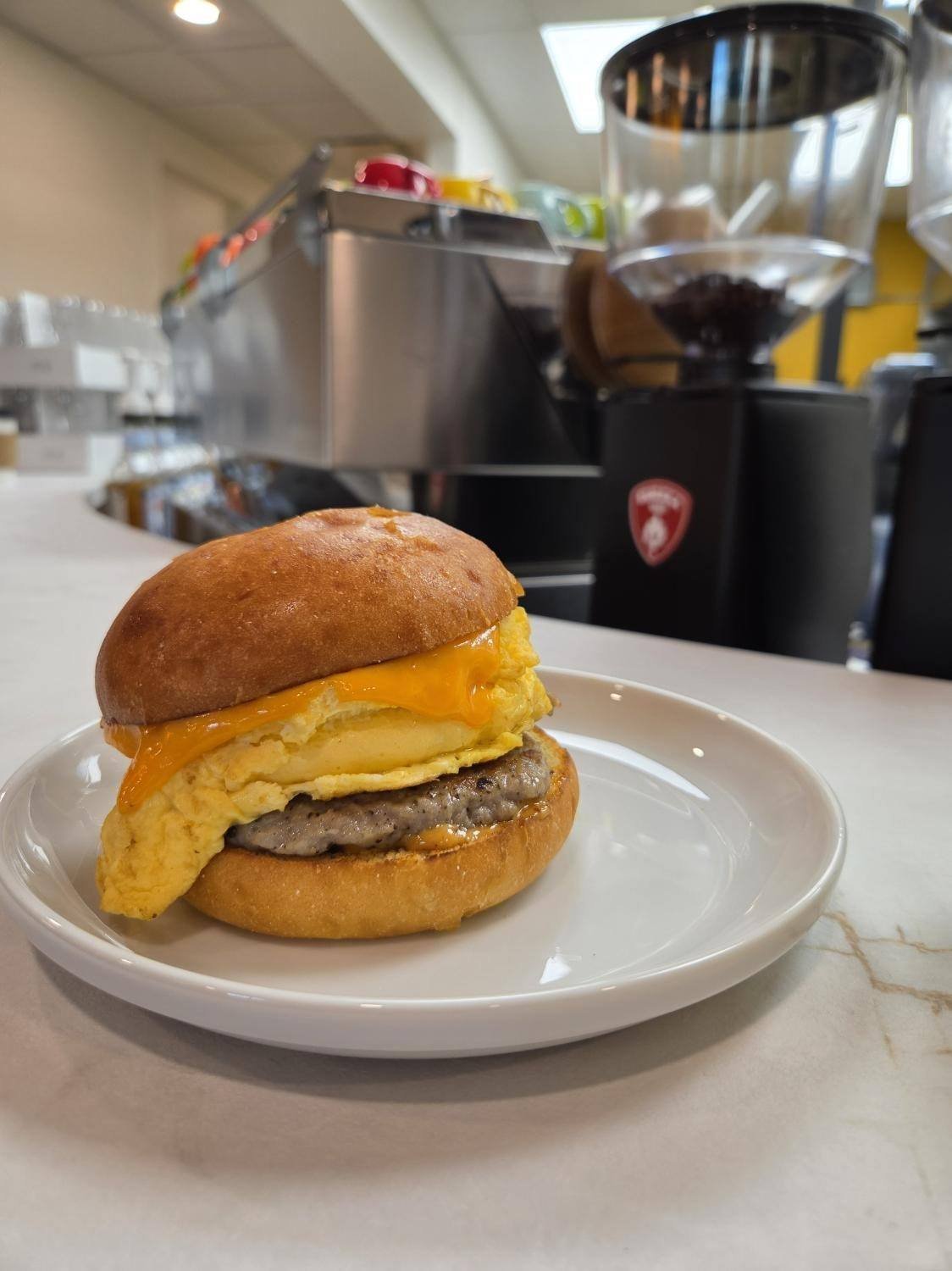 Classic breakfast sandwich with egg, sausage, and cheddar