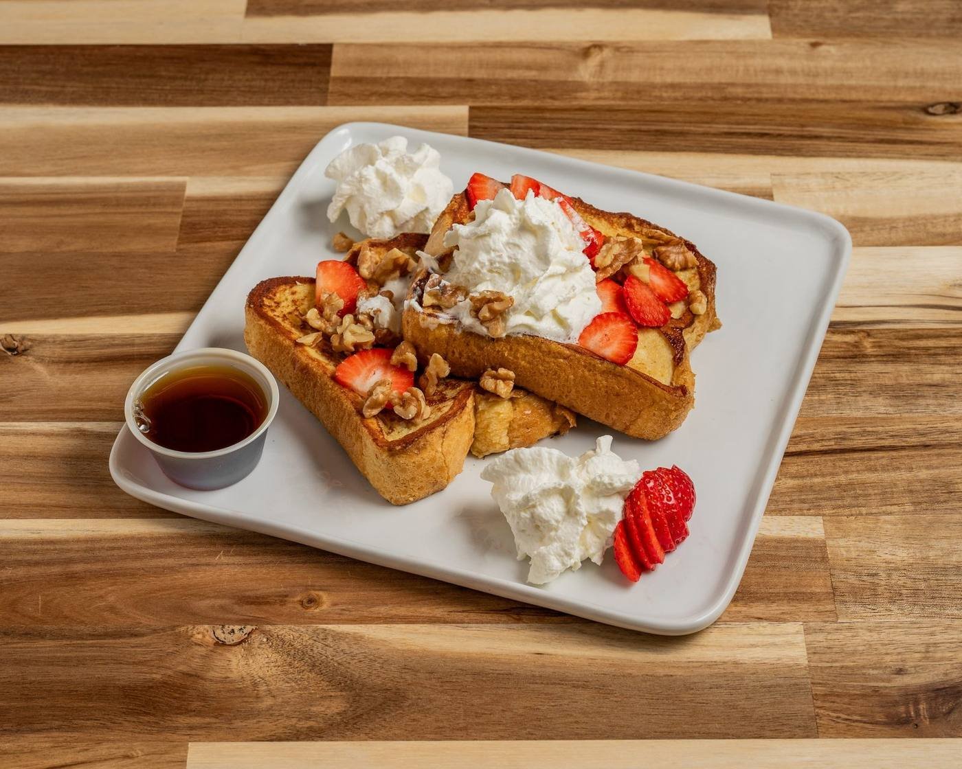 Brioche French toast with berries, walnuts, and whipped cream